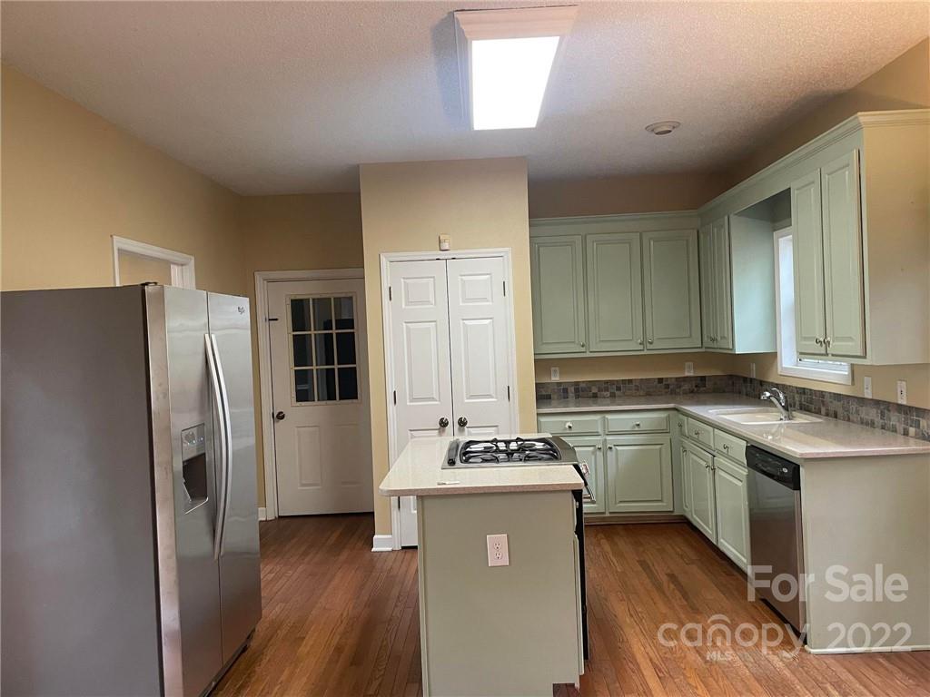 1014 Briarcliff Road Mooresville, NC 28115 - Photo 6 of 27 a kitchen with a sink stove and refrigerator