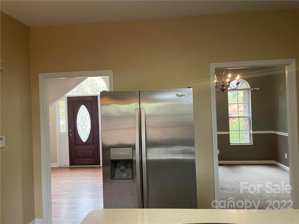 1014 Briarcliff Road Mooresville, NC 28115 - Photo 8 of 27 a kitchen with a refrigerator and mirror