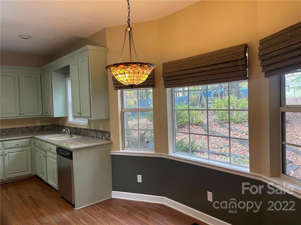 1014 Briarcliff Road Mooresville, NC 28115 - Photo 9 of 27 a open kitchen with stainless steel appliances granite countertop a stove and a sink
