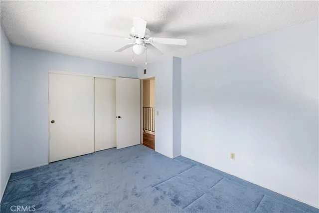 a view of an empty room with a fan