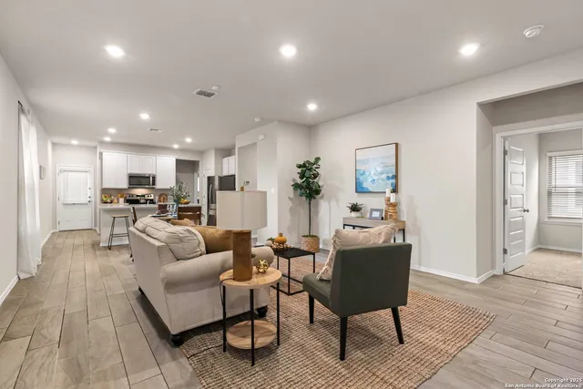 a living room with furniture kitchen and a table