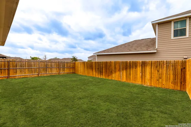 a view of yard with swimming pool and green space