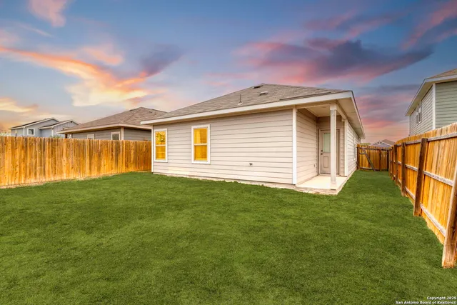 a view of a house with a backyard