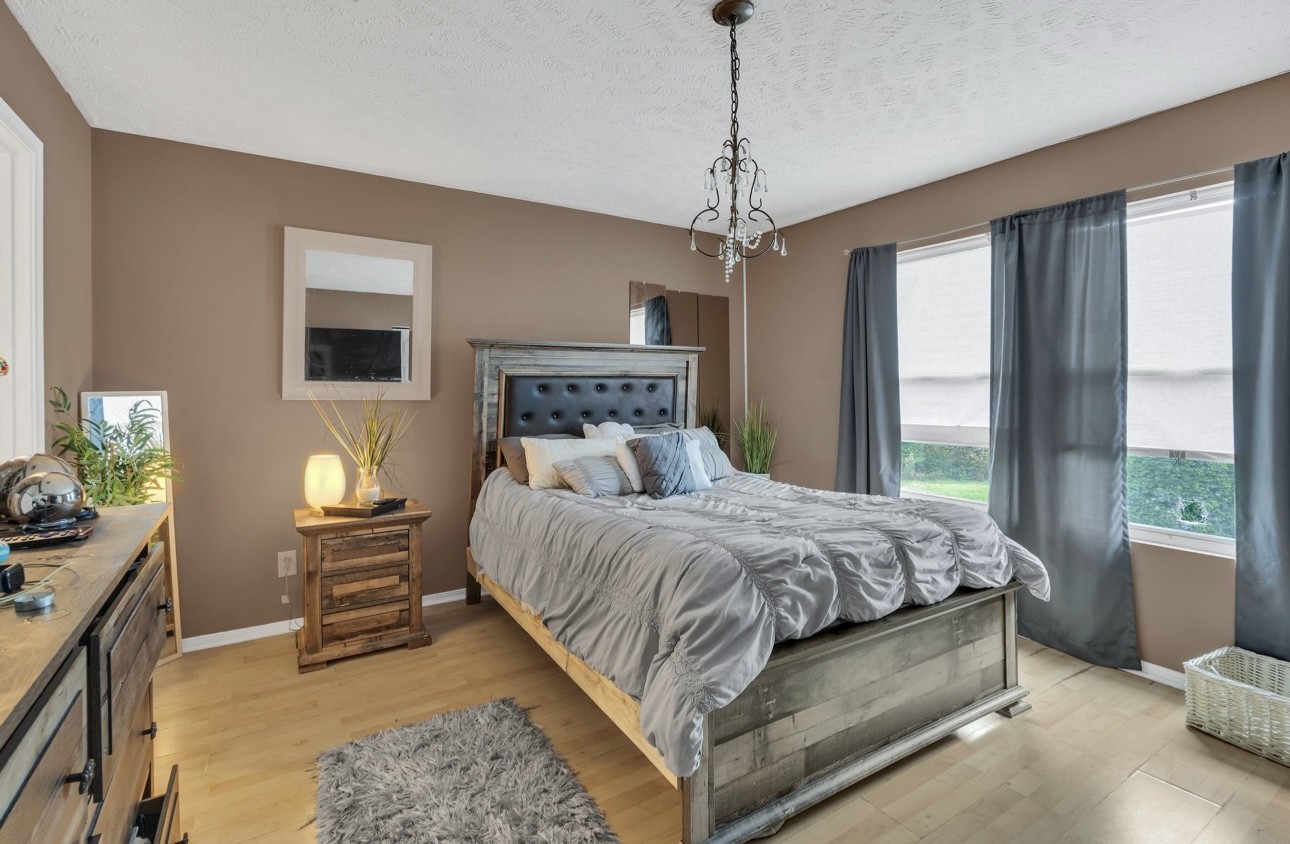 Undisclosed Address Antioch, TN 37013 - Photo 12 of 18 a bedroom with a bed chandelier and a window