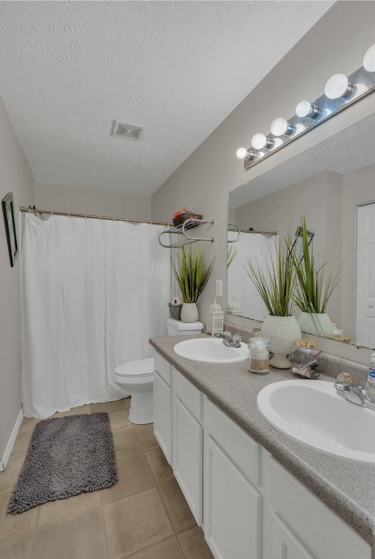 Undisclosed Address Antioch, TN 37013 - Photo 13 of 18 a bathroom with a double vanity sink and a mirror