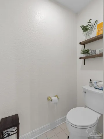 a white toilet sitting next to a bathroom sink