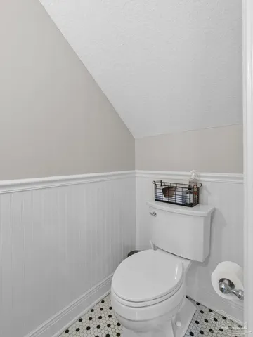 a white toilet sitting next to a small sink