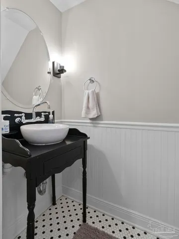 a bathroom with a sink a toilet and mirror