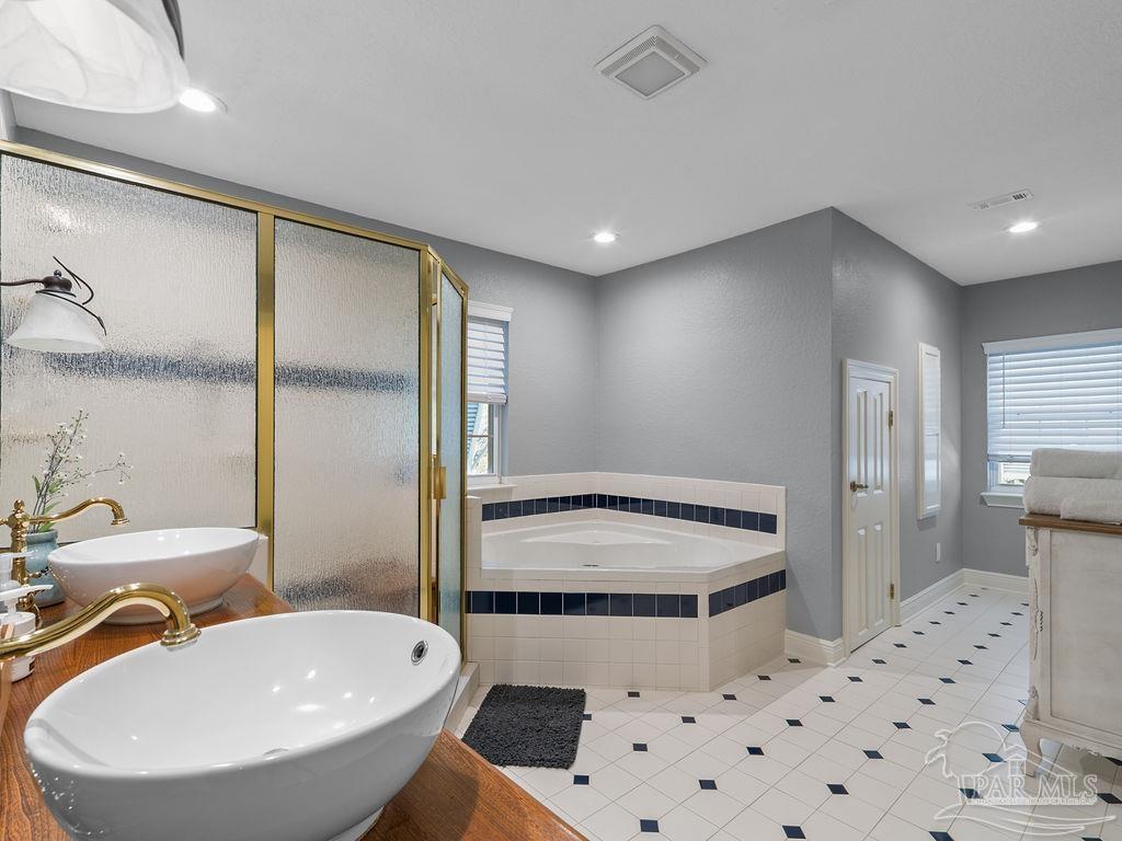 10152 Bittern Drive Pensacola, FL 32507 - Photo 19 of 45 a bathroom with a sink a toilet a mirror and shower