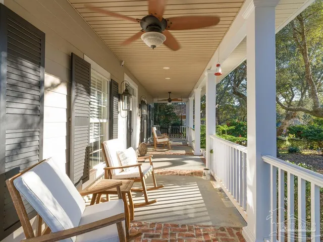 a view of a patio with a table chairs and wooden floor