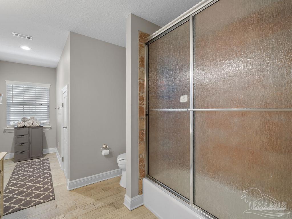 10152 Bittern Drive Pensacola, FL 32507 - Photo 22 of 45 a bathroom with a shower and a glass door