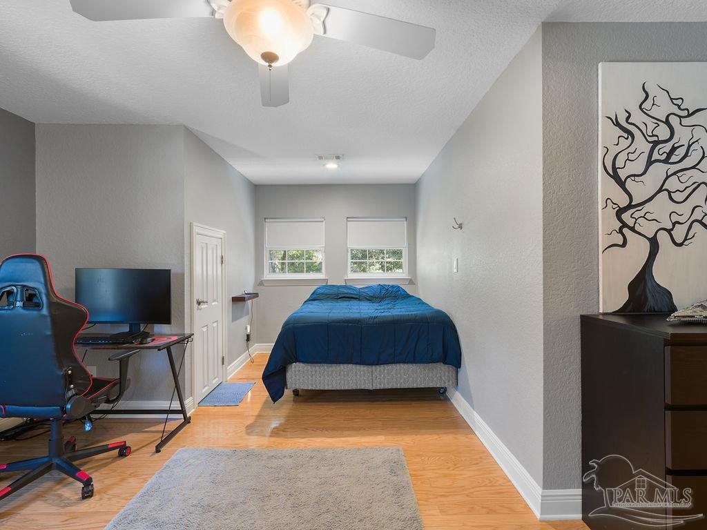 10152 Bittern Drive Pensacola, FL 32507 - Photo 24 of 45 a bedroom with furniture and a flat screen tv