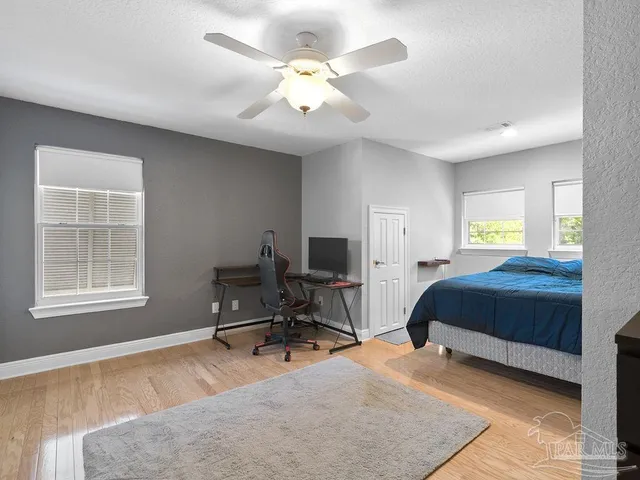 a bedroom with a bed a table and chair