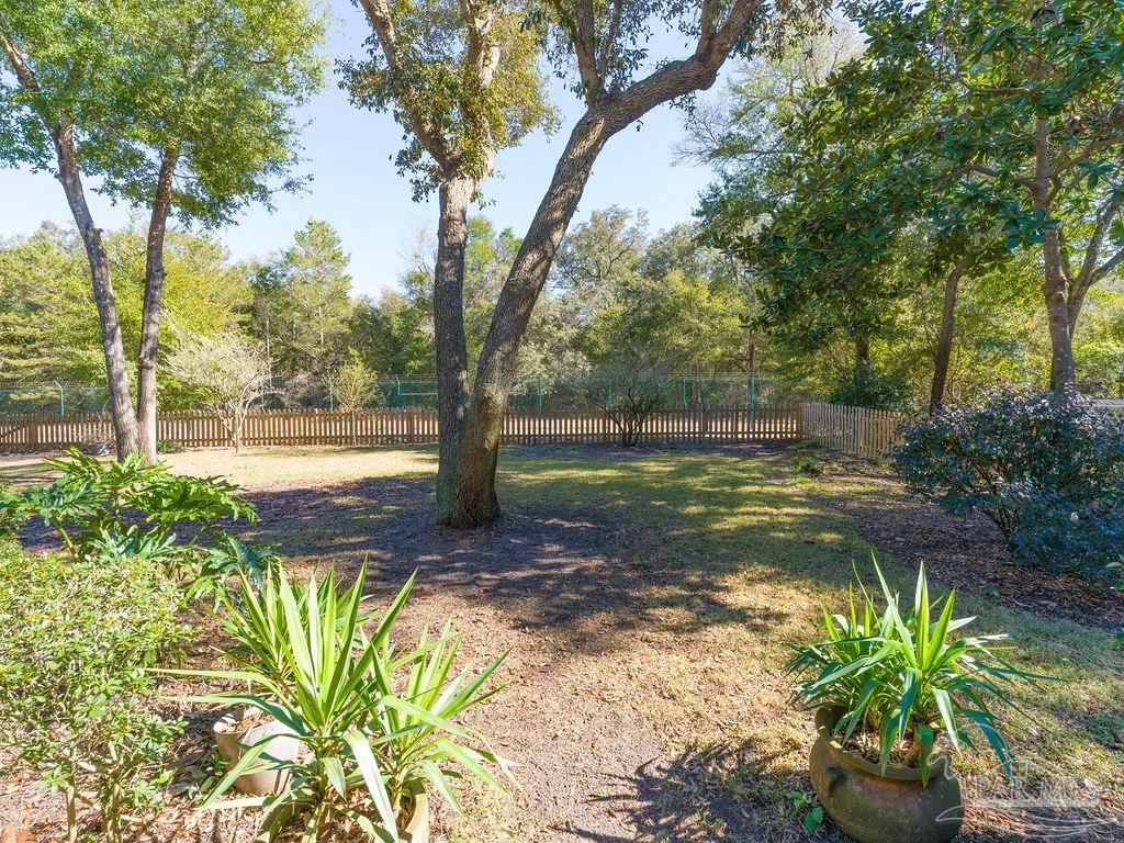 10152 Bittern Drive Pensacola, FL 32507 - Photo 30 of 45 a view of a yard with a tree