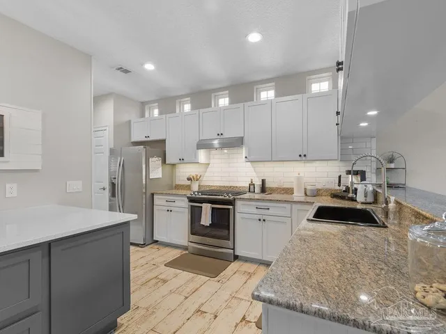 a kitchen with a sink stove and refrigerator