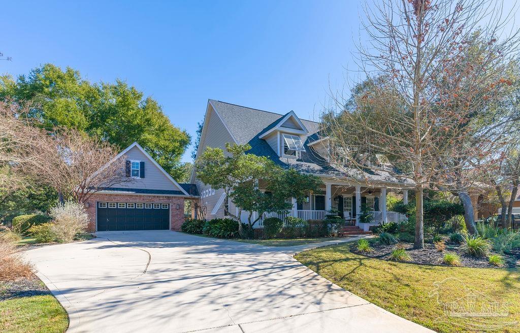 10152 Bittern Drive Pensacola, FL 32507 - Photo 34 of 45 a front view of a house with a yard and potted plants