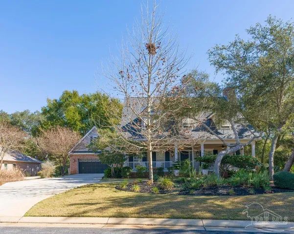 a front view of a house with yard and green space