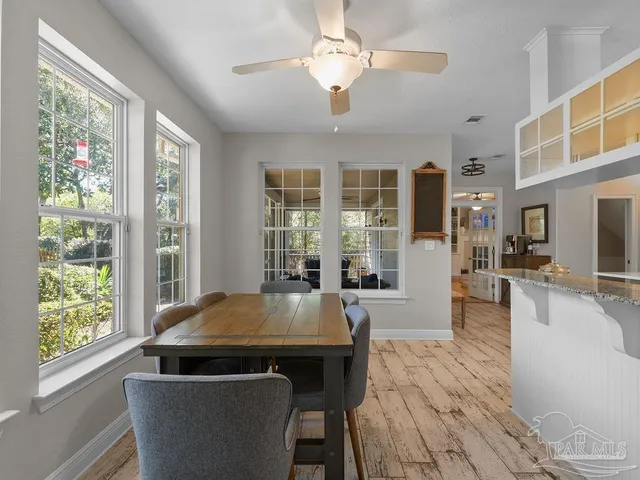a living room with furniture and large windows