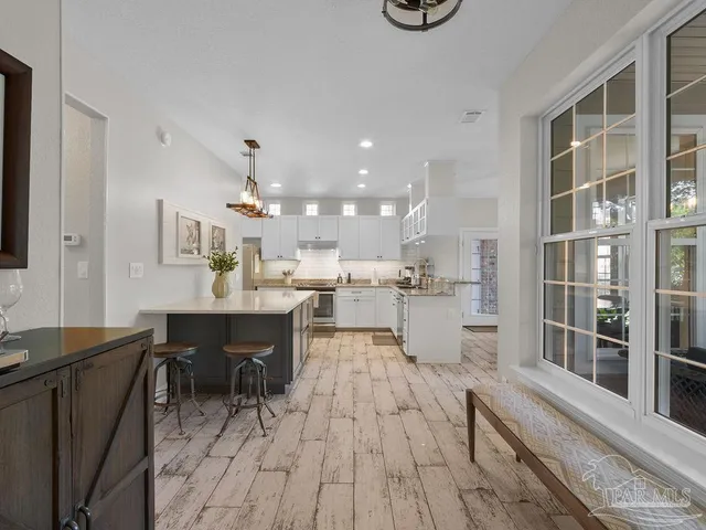 a view of a dining room kitchen with furniture and wooden floor
