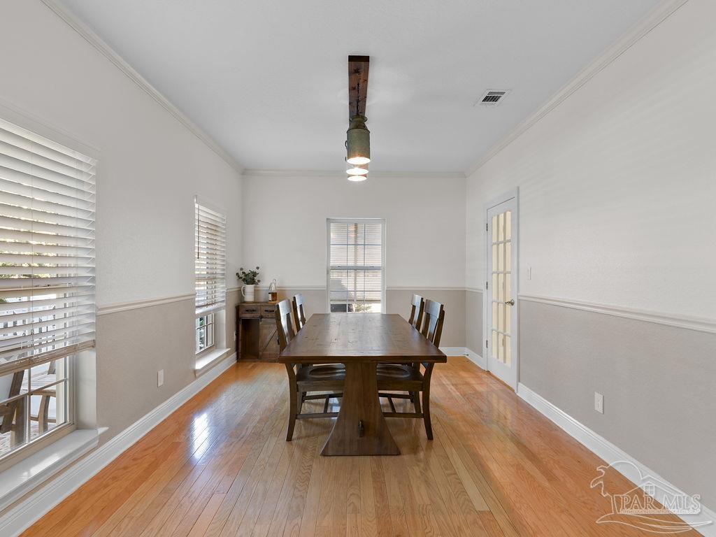10152 Bittern Drive Pensacola, FL 32507 - Photo 9 of 45 a view of a dining room with furniture window and wooden floor