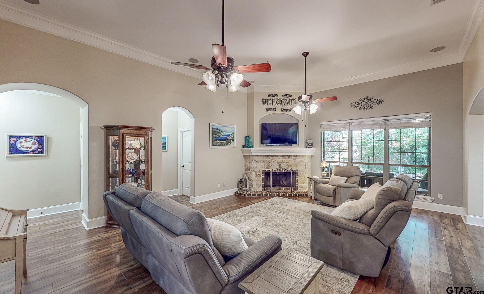 18488 Bluebird Circle Flint, TX 75762 - Photo 5 of 47 a living room with furniture a fireplace and a chandelier