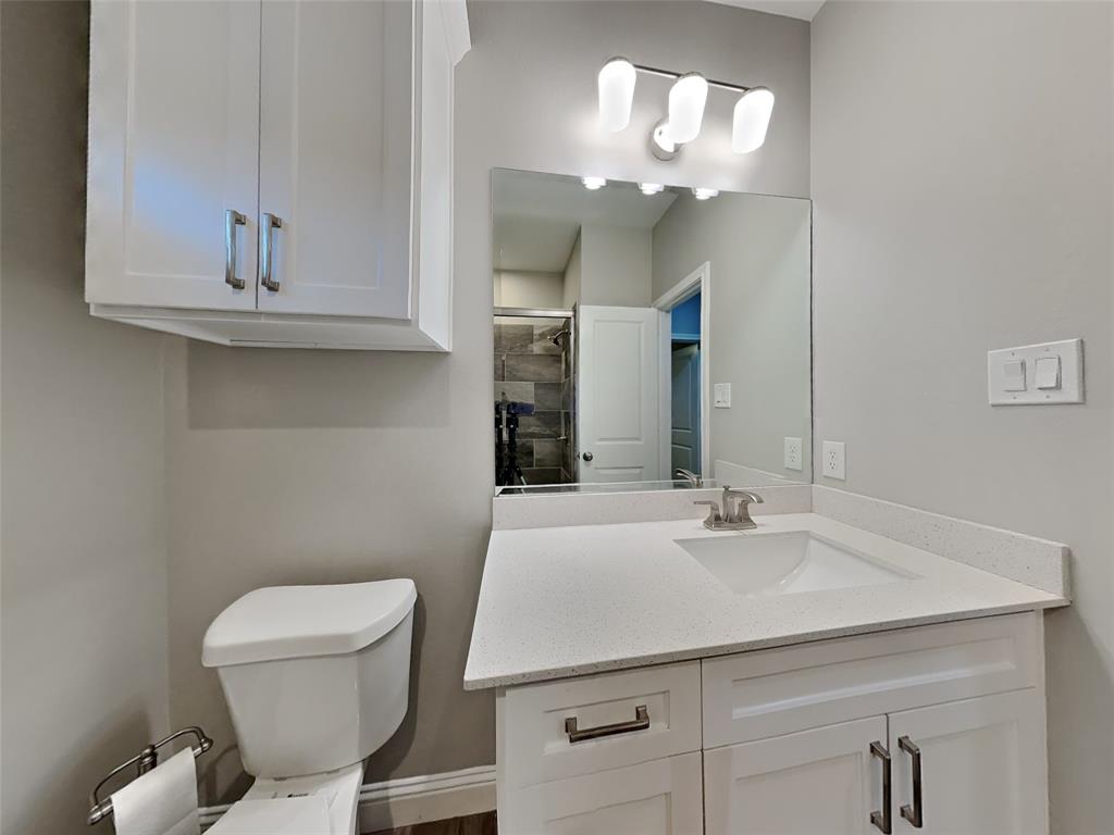 2512 Sharon Street Dallas, TX 75211 - Photo 15 of 17 a bathroom with a sink a toilet and a mirror
