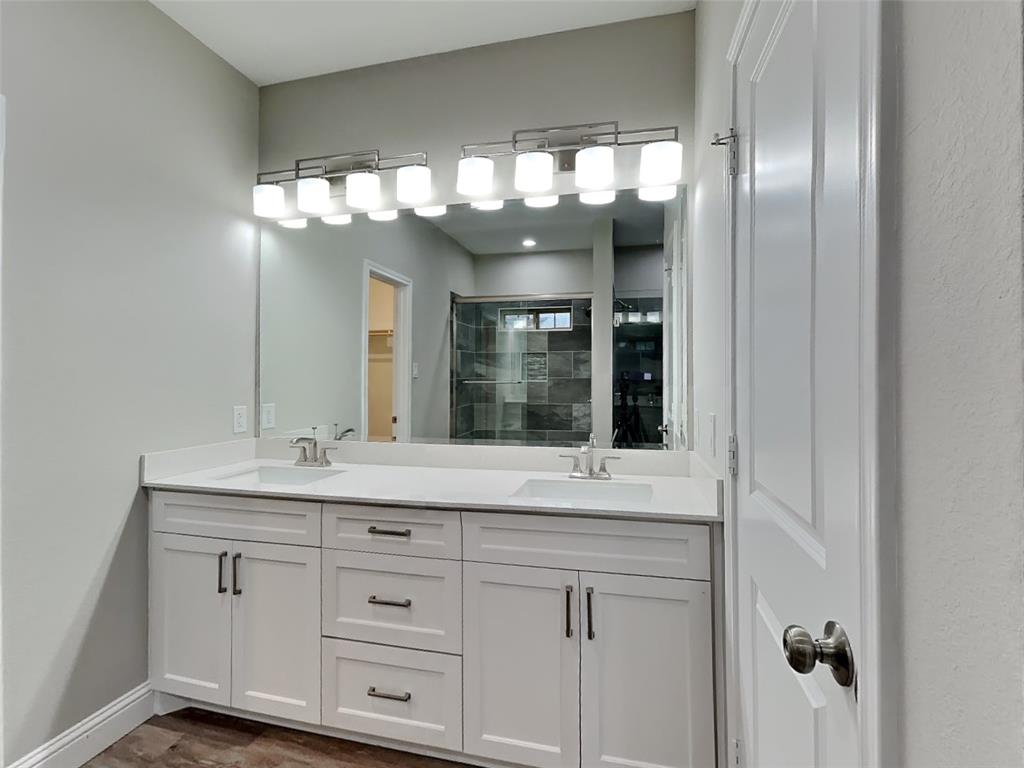 2512 Sharon Street Dallas, TX 75211 - Photo 9 of 17 a bathroom with a sink and a large mirror