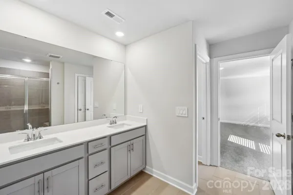 a bathroom with a double vanity sink mirror and double