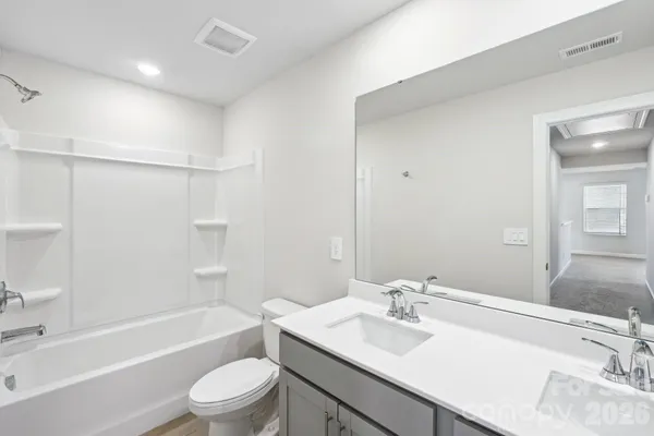 a bathroom with a sink toilet tub and shower