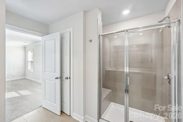 a bathroom with a glass shower door