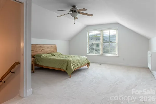 a bedroom with a bed and ceiling fan