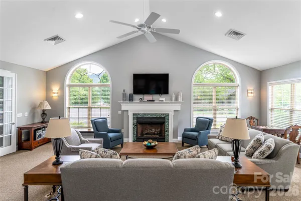 a kitchen with stainless steel appliances granite countertop a table and chairs in it