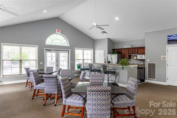 a room with pool table and windows
