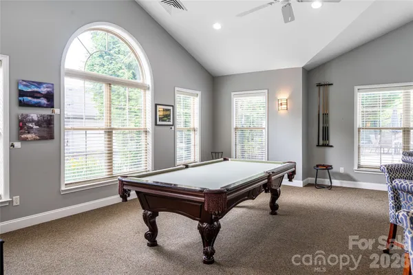 a view of a dining room and livingroom with furniture window and a view of kitchen
