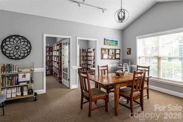 a living room with a book shelf and a book shelf