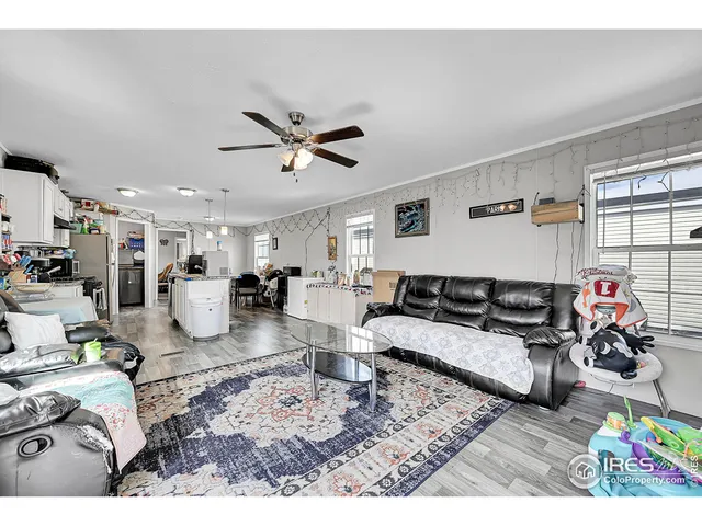 a living room with furniture and kitchen view