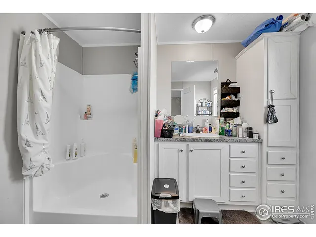 a bathroom with a double vanity sink mirror and shower