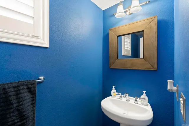 a bathroom with a sink mirror and vanity