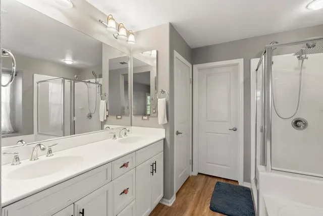 a spacious bathroom with a double vanity sink mirror and double