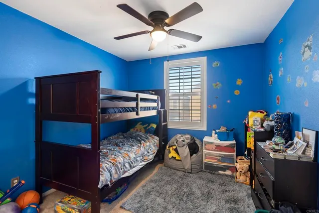 a bedroom with bed and a window