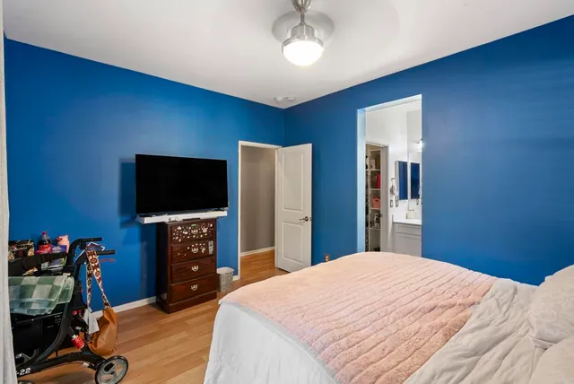 a bedroom with a bed and a flat screen tv