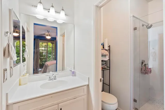 a bathroom with a sink a toilet and shower