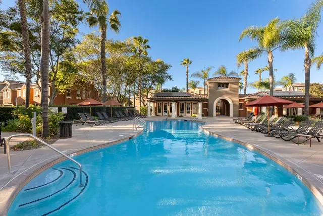 a swimming pool with outdoor seating and yard