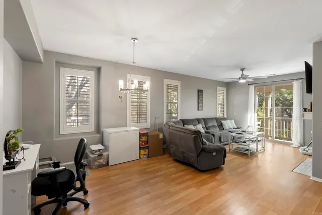 a living room with furniture window and wooden floor