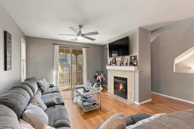 a living room with furniture a flat screen tv and a fireplace