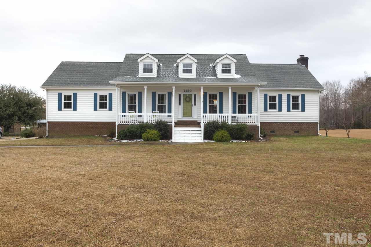 7850 James Austin Road Willow Spring, NC 27592 - Photo 1 of 25 a front view of a house with a yard