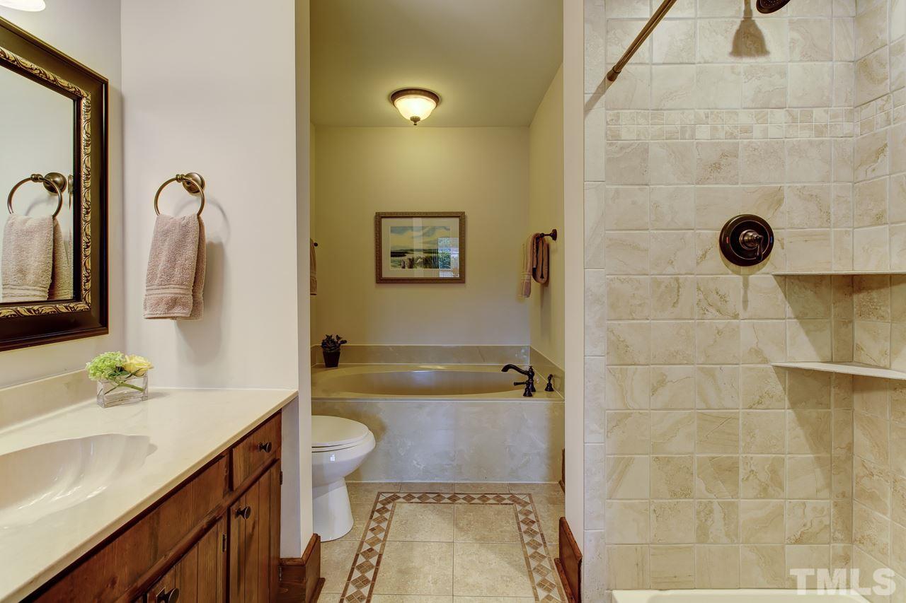 7850 James Austin Road Willow Spring, NC 27592 - Photo 12 of 25 a bathroom with a granite countertop sink a toilet and a mirror