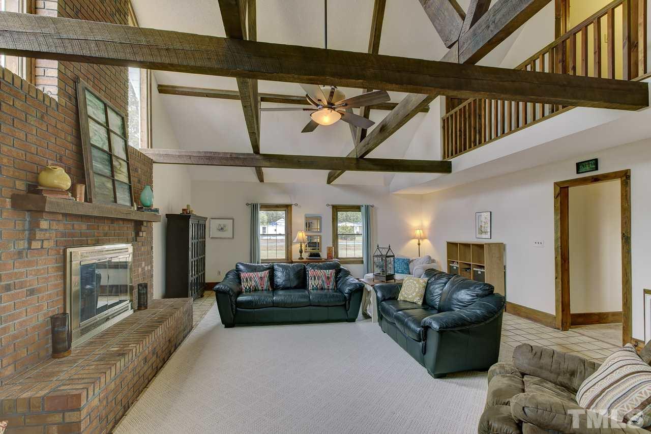 7850 James Austin Road Willow Spring, NC 27592 - Photo 13 of 25 a living room with furniture and a fireplace