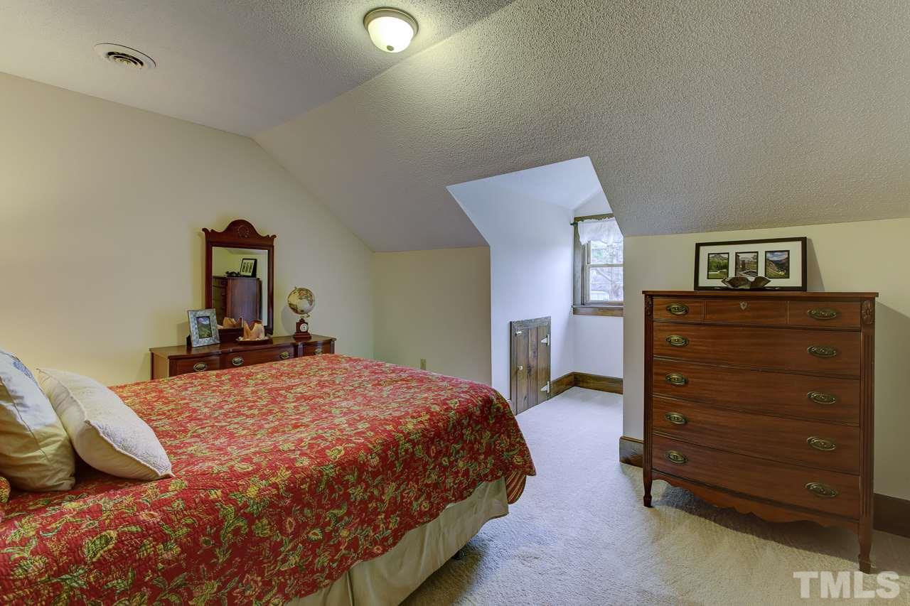 7850 James Austin Road Willow Spring, NC 27592 - Photo 15 of 25 a bedroom with a bed and a dresser