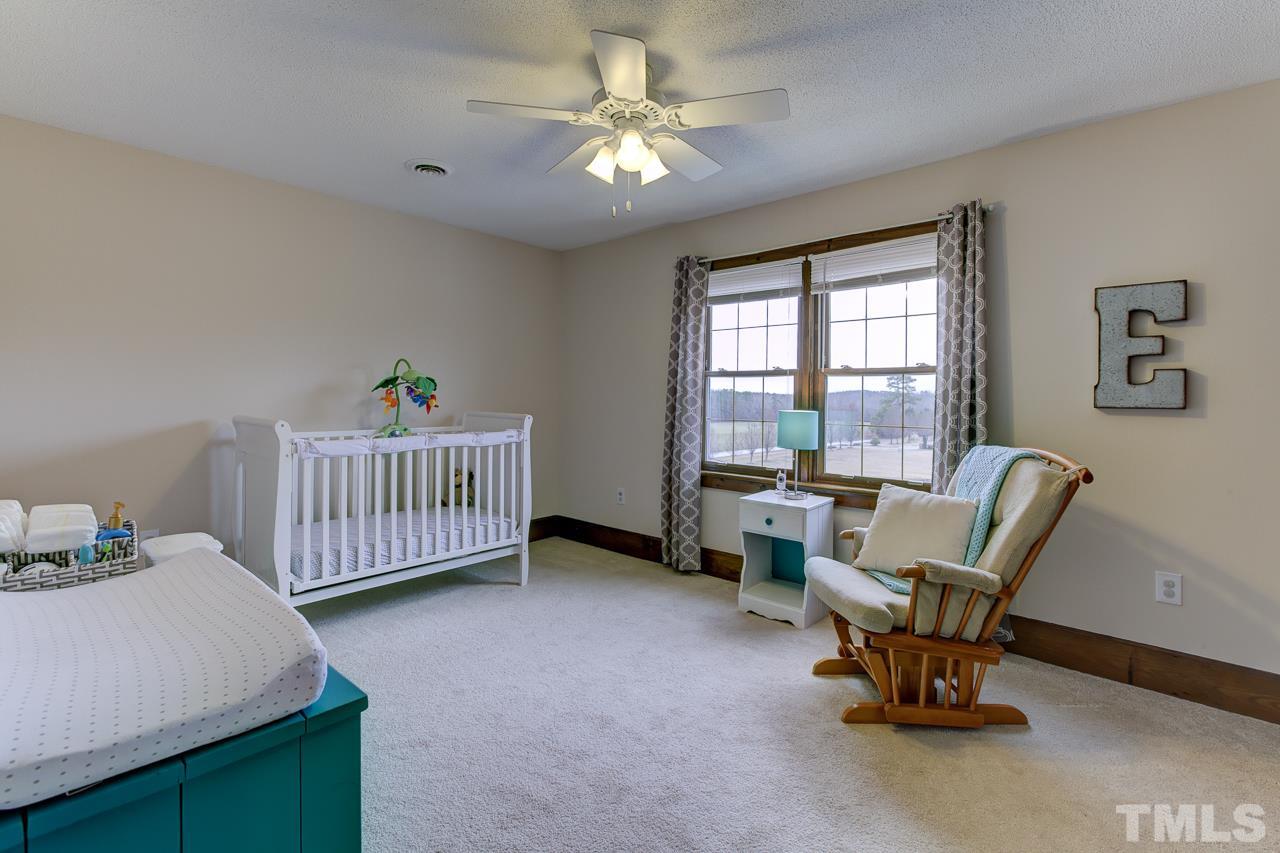 7850 James Austin Road Willow Spring, NC 27592 - Photo 17 of 25 a living room with furniture and a window